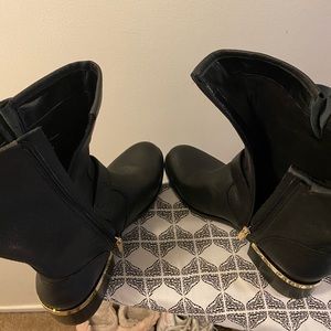 Black Leather Boots with gold buckle detail.